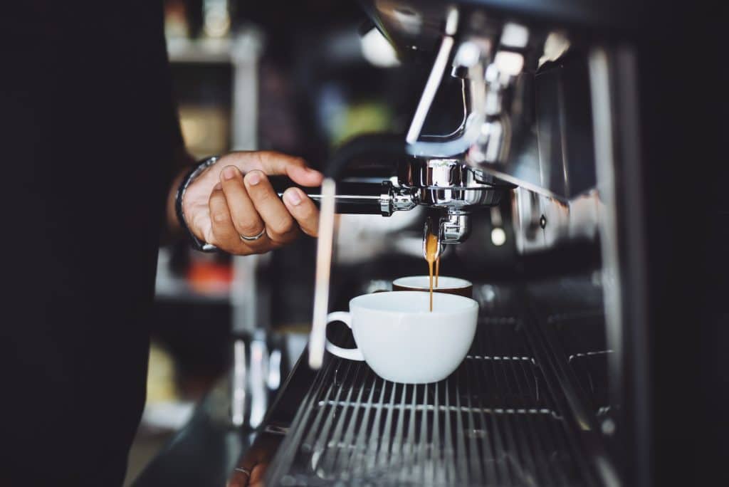 Cafe Jobs Brighton. A picture of a barista preparing coffee