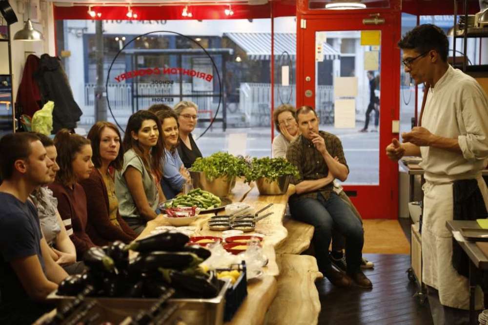 Messa teaching his guests at Brighton Cookery School 