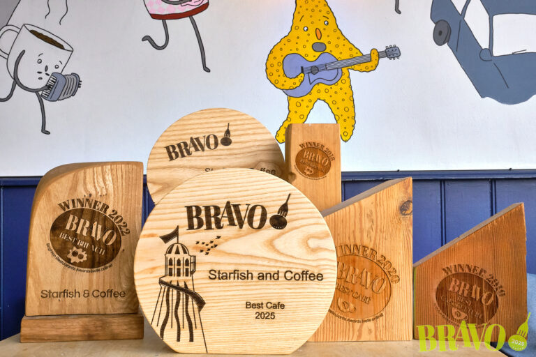 Multiple BRAVO winning trophies on a table at Starfish and Coffee