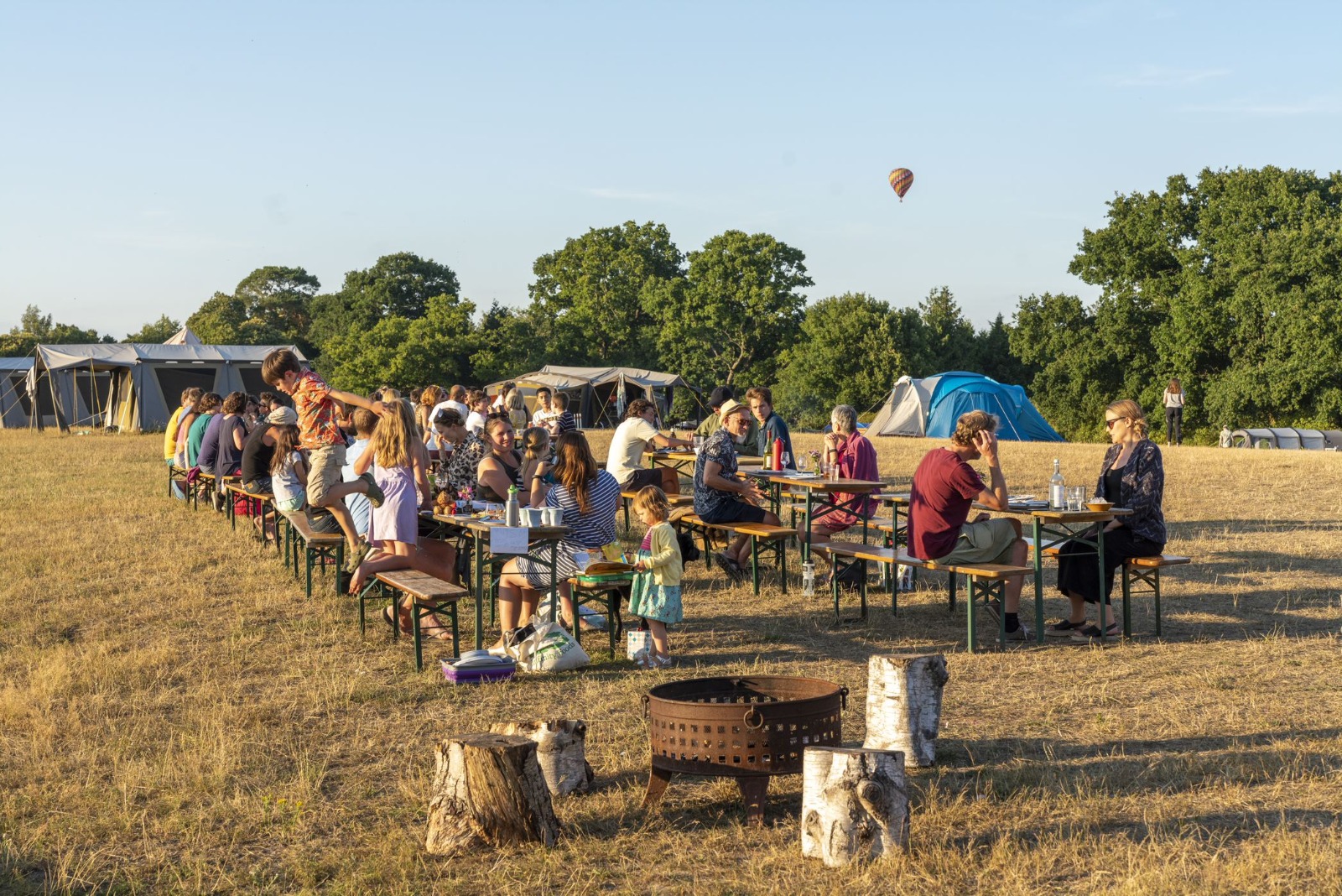 people sitting on the benches at the Woodfire Campsite