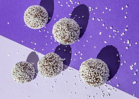 chocolate oat balls on a purple background