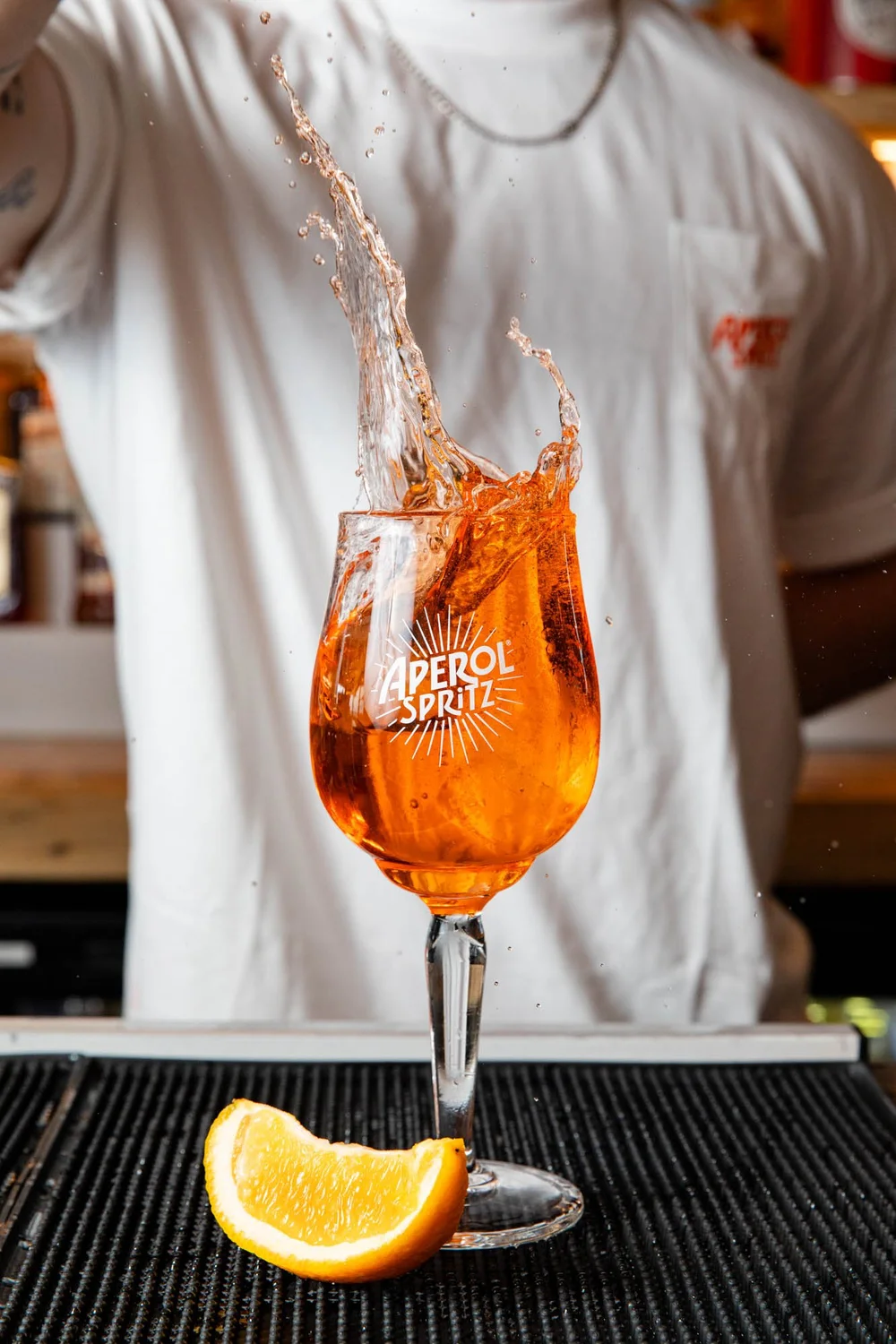 Aperol Spritz, with ice, with bartender making a big splash