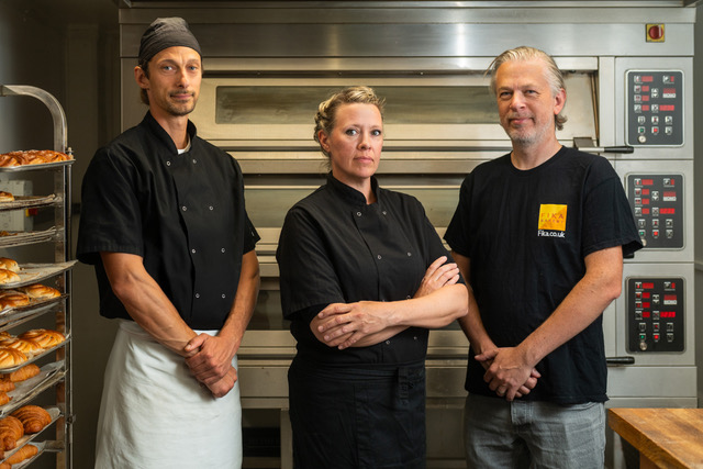 What is Fika? Fika Ltd in Brighton. Pictured - head baker Pawel Cichowski with directors Jenny Engvall Viv Craske. In an industrial looking kitchen