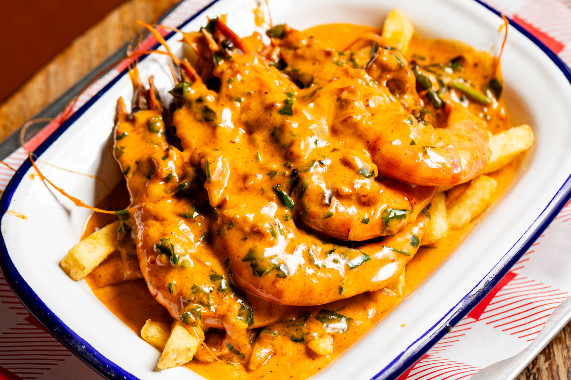 Tiger Prawns in a sauce, presented on a white plate