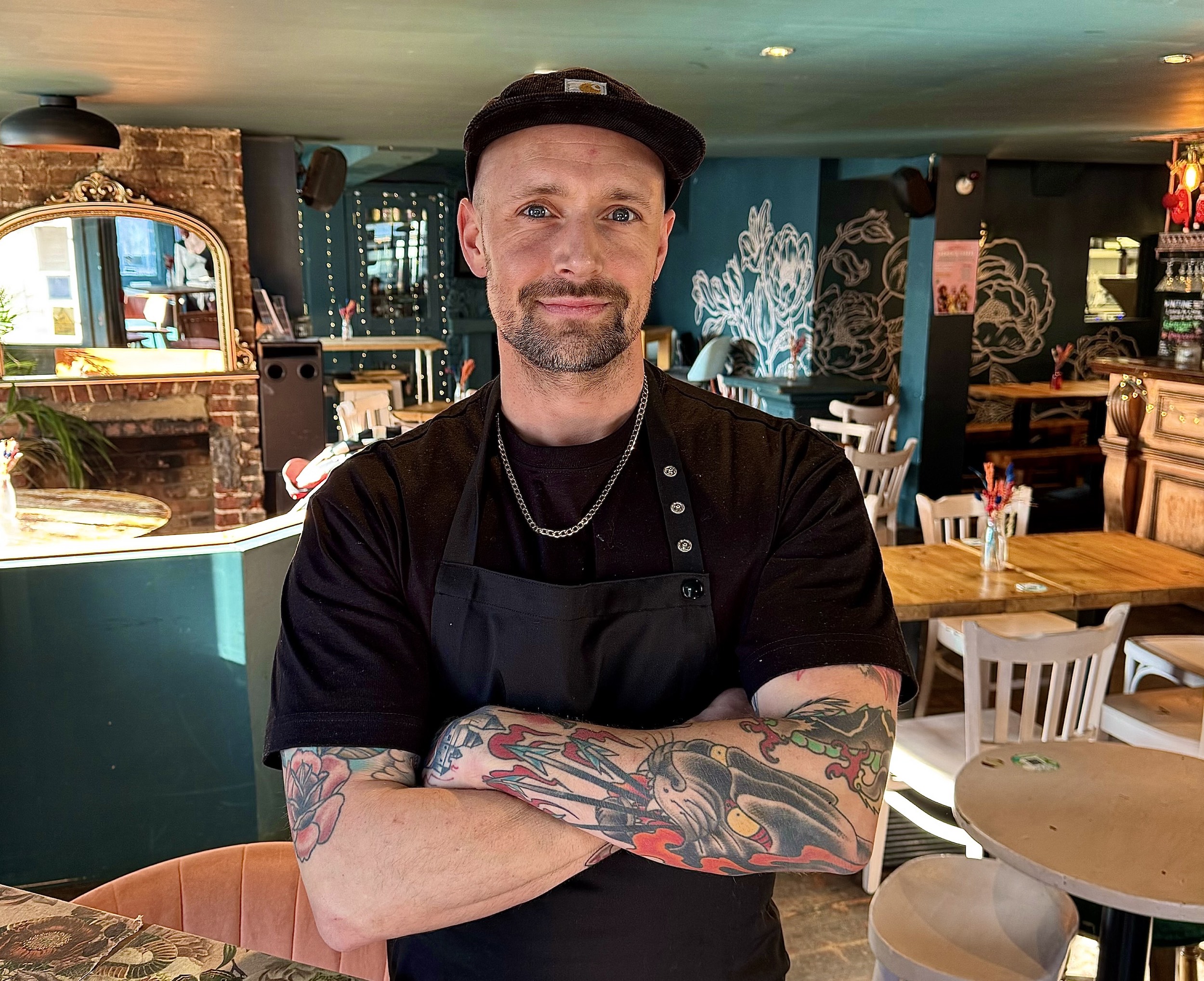 Chef Nick Wood standing inside the Fountain Head pub next to the bar. 