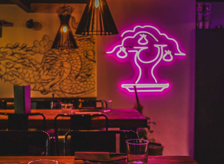 Neon signs and a dimly lit interior at Bonsai Plant Kitchen