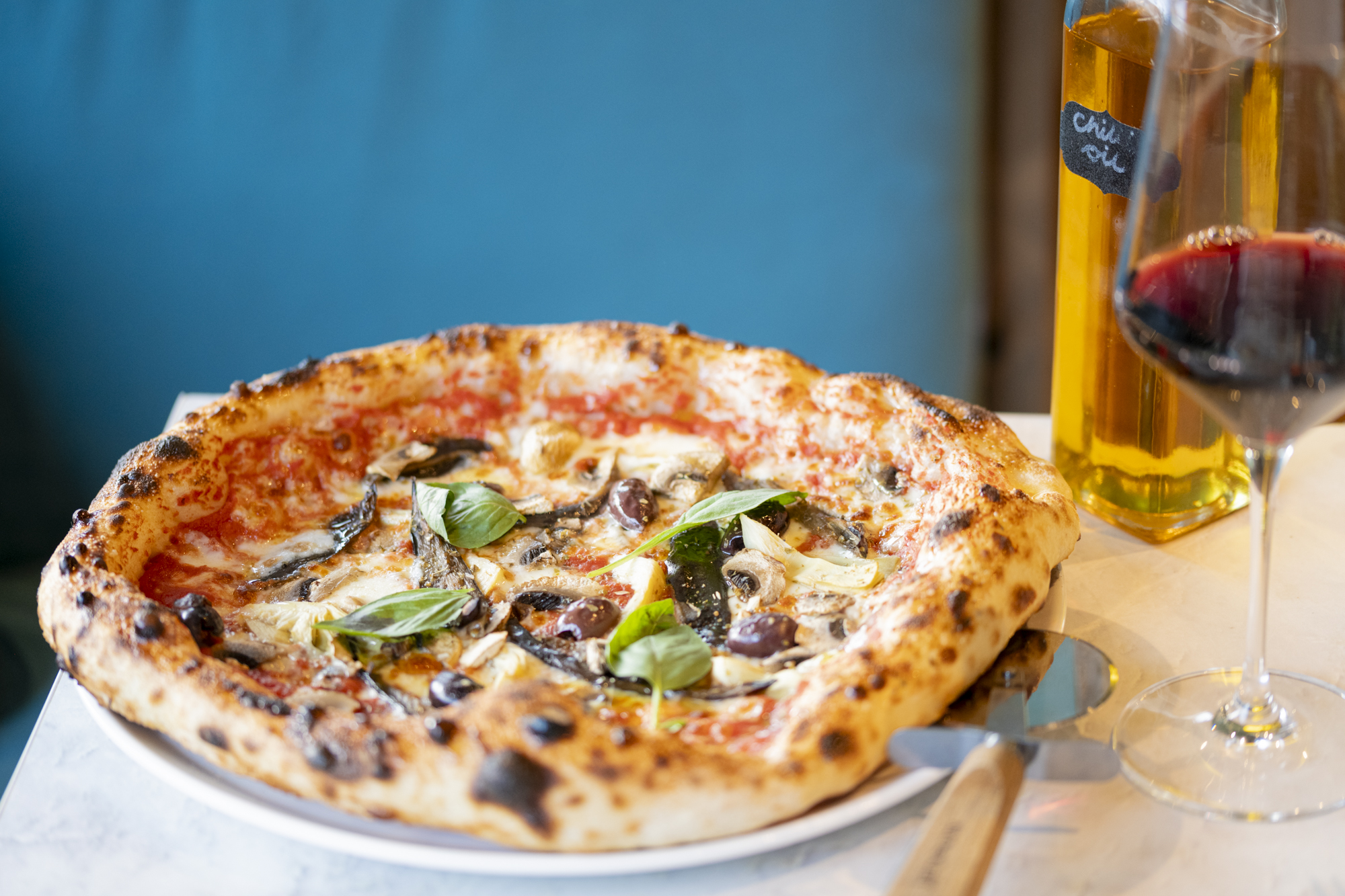 A pizza at Village Pizza Kitchen - Basil left over from pizzas is added to sauces 