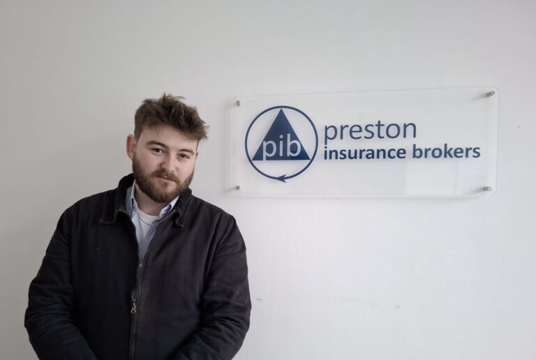Max Merriman at Preston Insurance Brokers, next to the Branding
