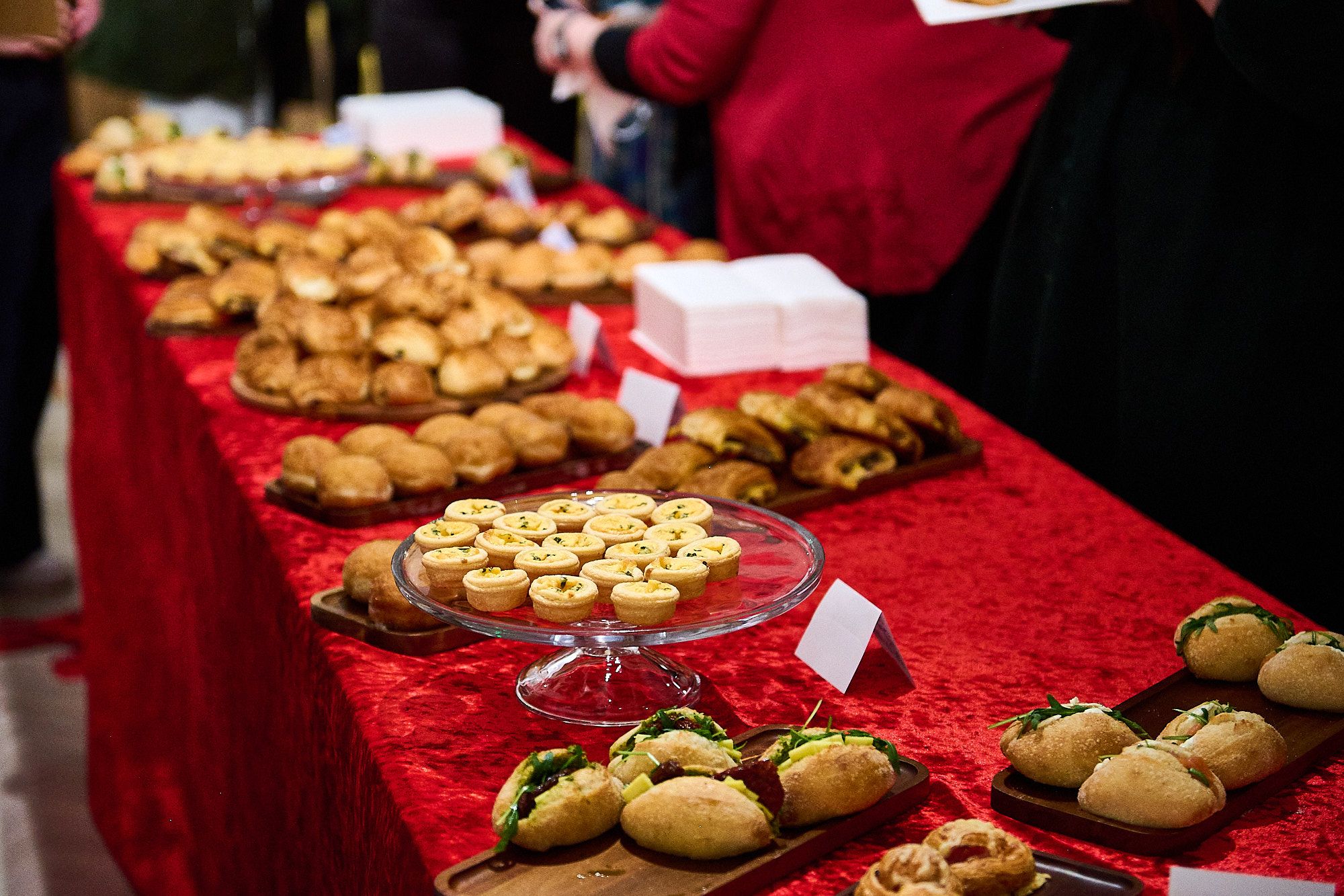 table laid out with red covered and loads of pastry from Bayon Bakery
