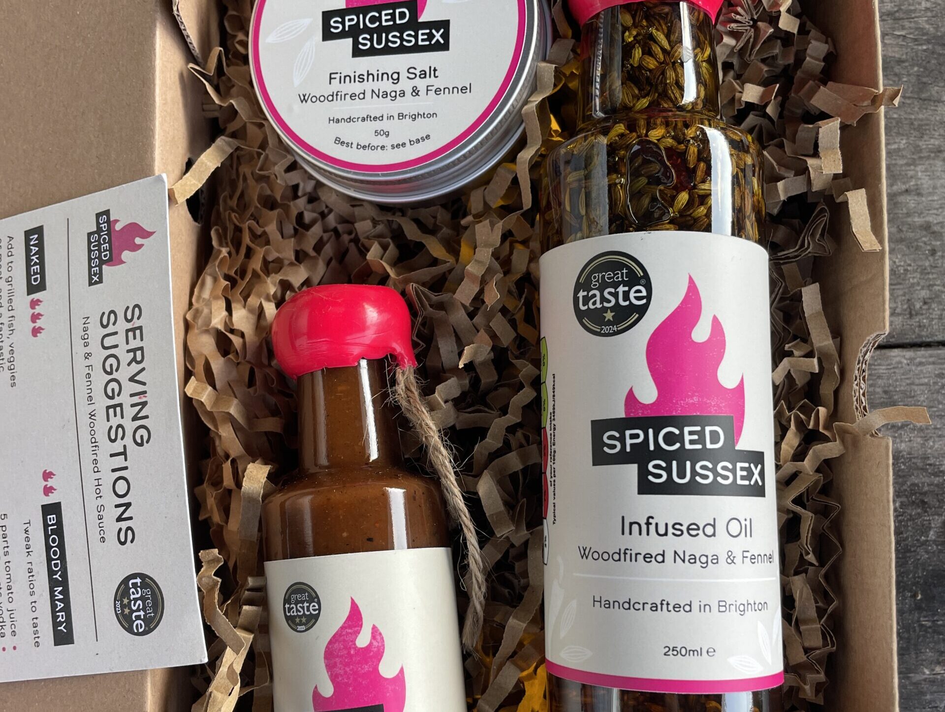 Spiced Sussex gift box of Great Taste award winning infused oil, sauce and finishing salt, handmade in Sussex, with a serving suggestions card.