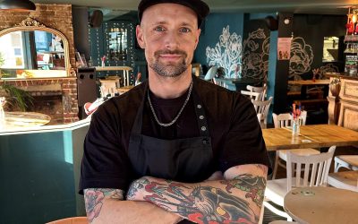 Nick Wood Chef – Boysterous Burgers Chef Nick Wood standing inside the Fountain Head pub next to the bar.