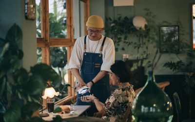 Restaurant owner using contactless payment system