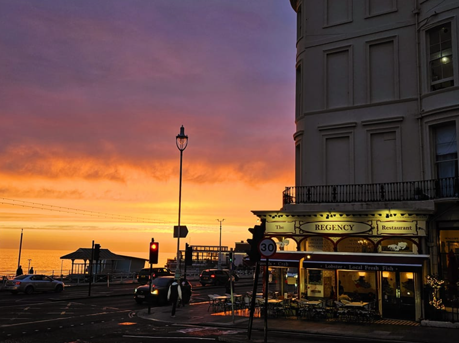 as sunset view of the Regency restaurant in Brighton - overlooking Brighton Beach