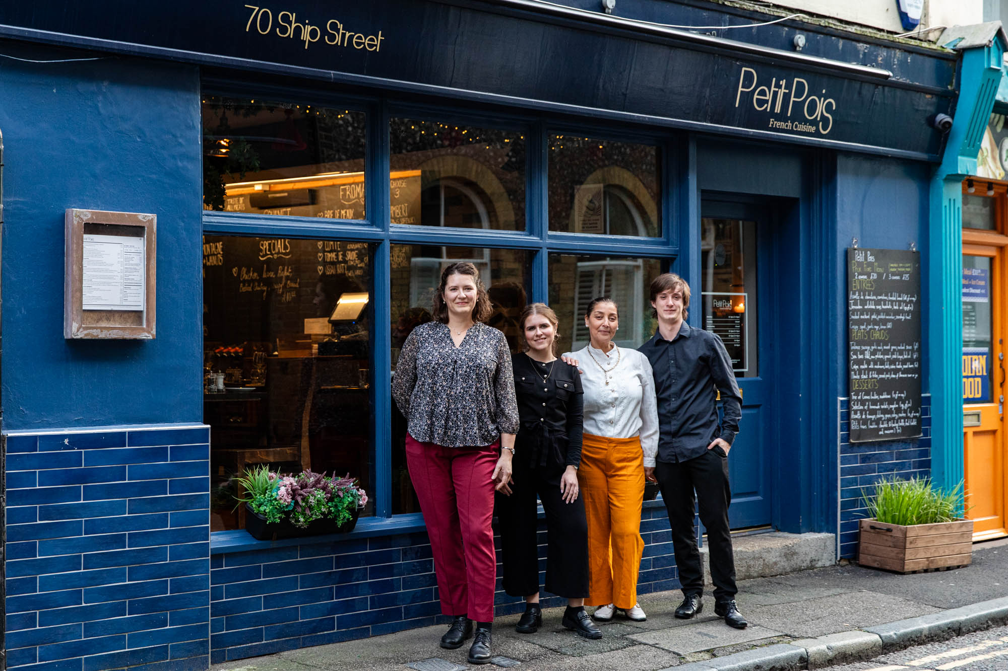 exterior shot of the petit pois, team taking picture in front of the venue