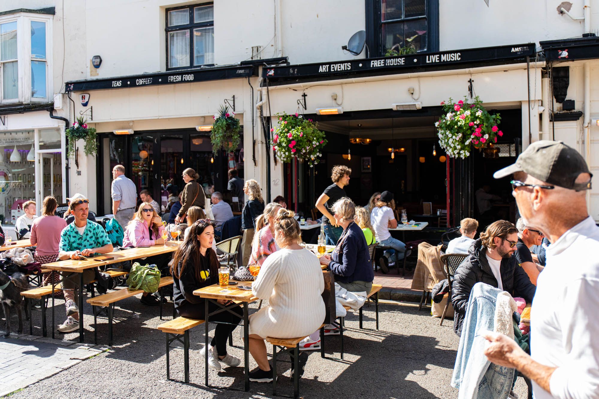 People sitting outside The Dorset pub in the North Laine. It's a sunny day