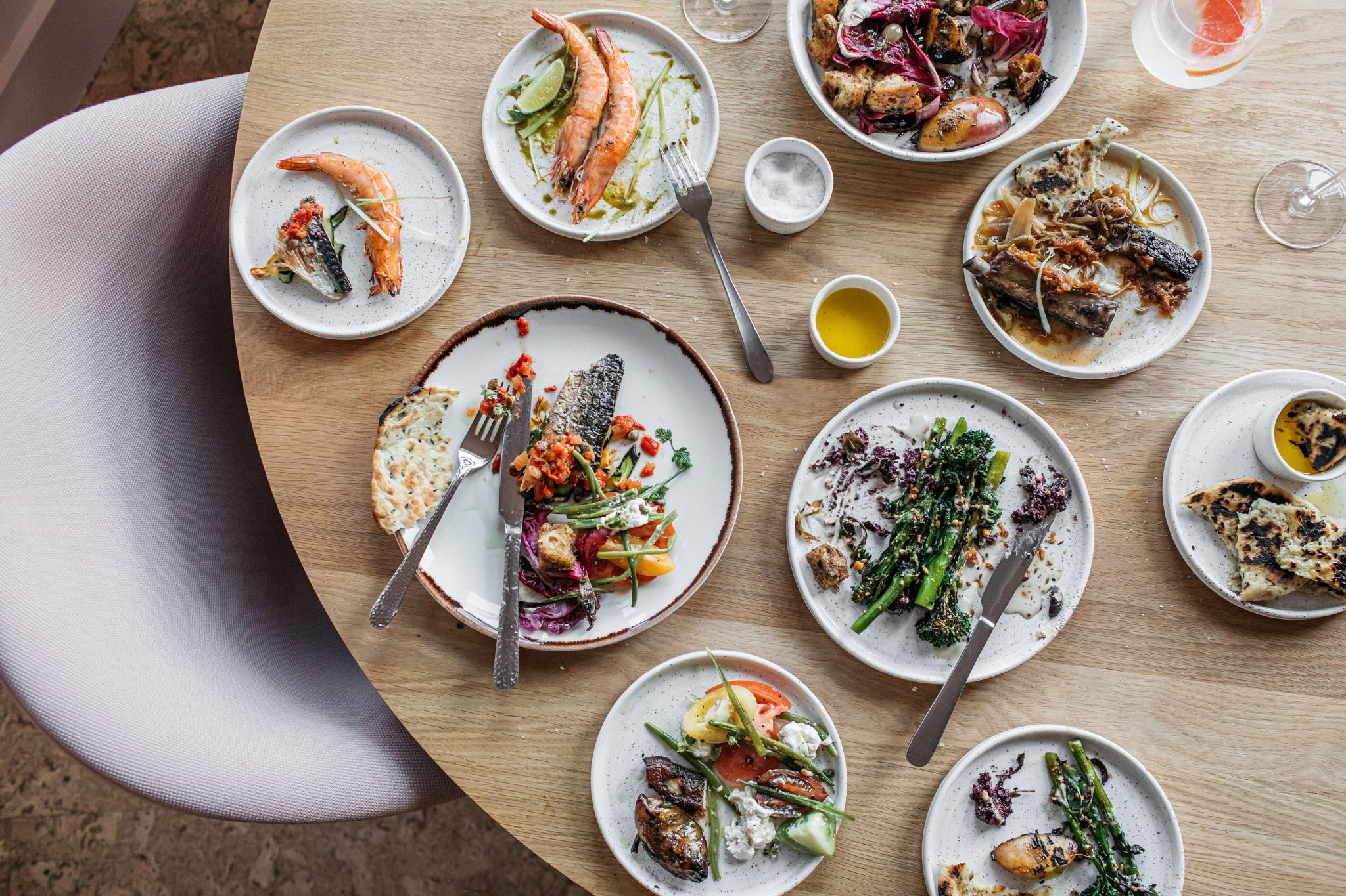 overhead shot of table laid out with small plates and drinks