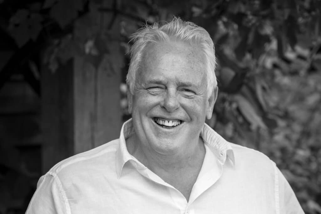 Black and white photo of Simon Hope, a man with light hair smiling