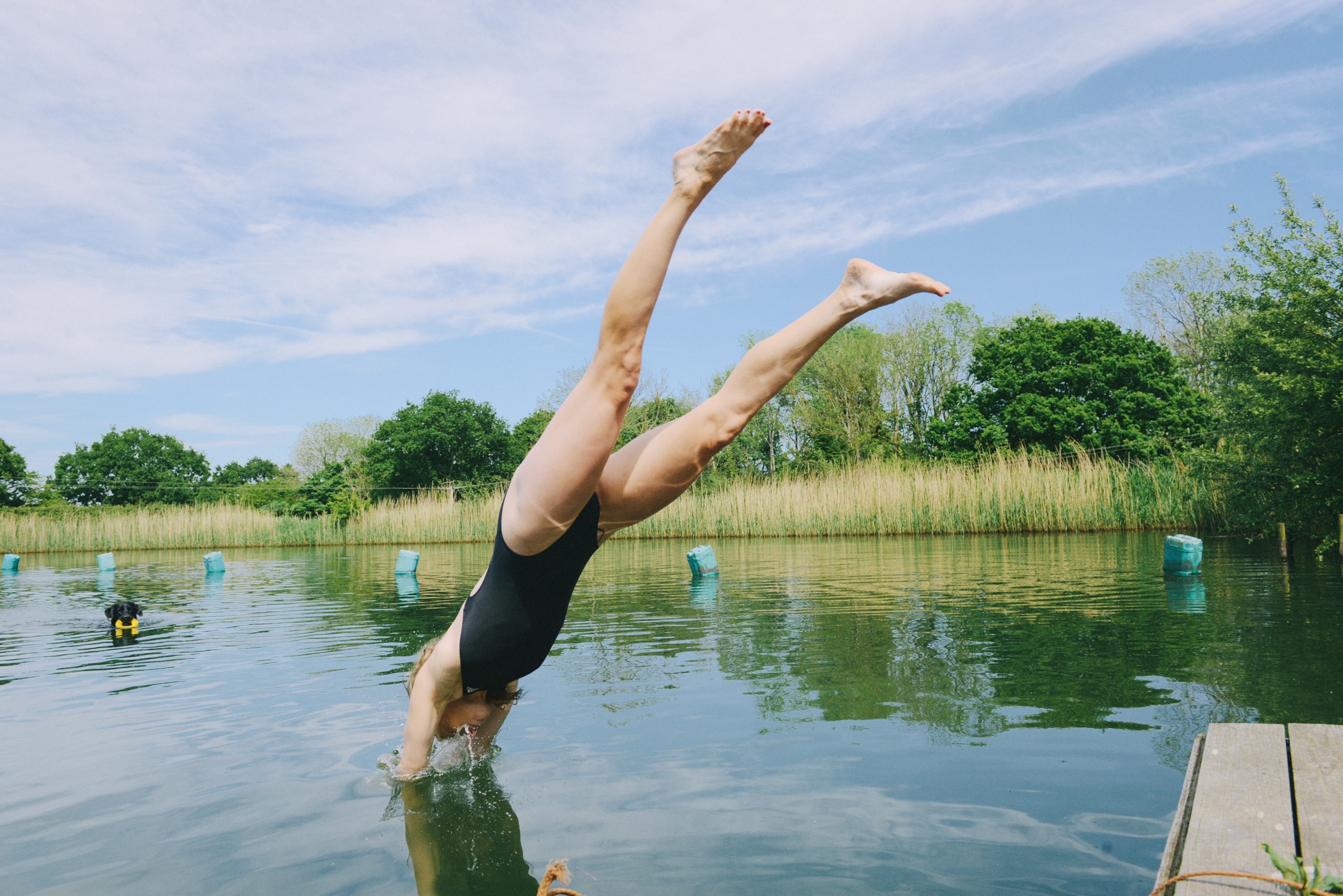 Woman jumping in the lake for a swin