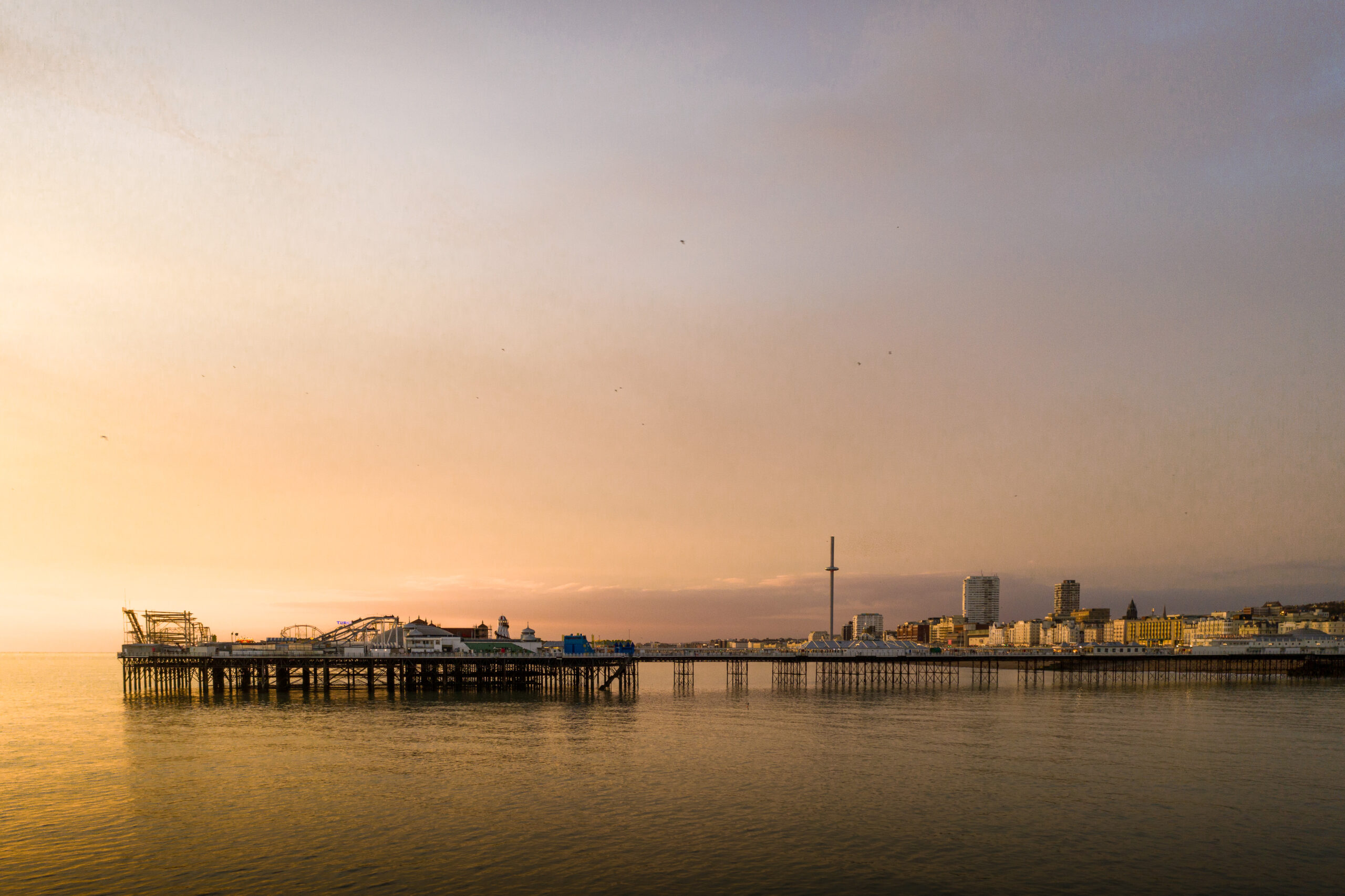 A drone photo of Brighton pier during a sunset with a clear sky.Taken by photographer Neil Barclay. Easter Bank Holiday Weekend.