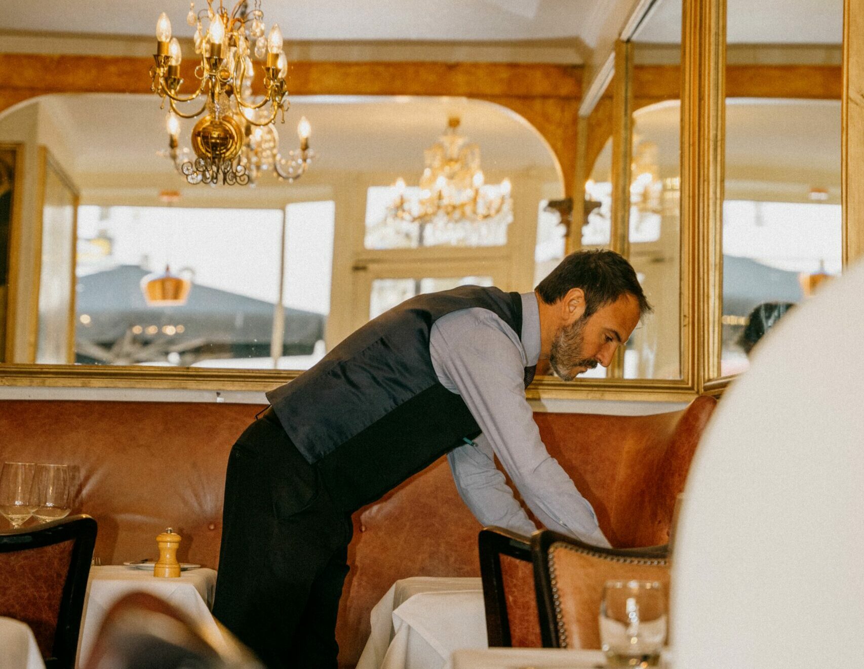 waiter setting up the table at English's