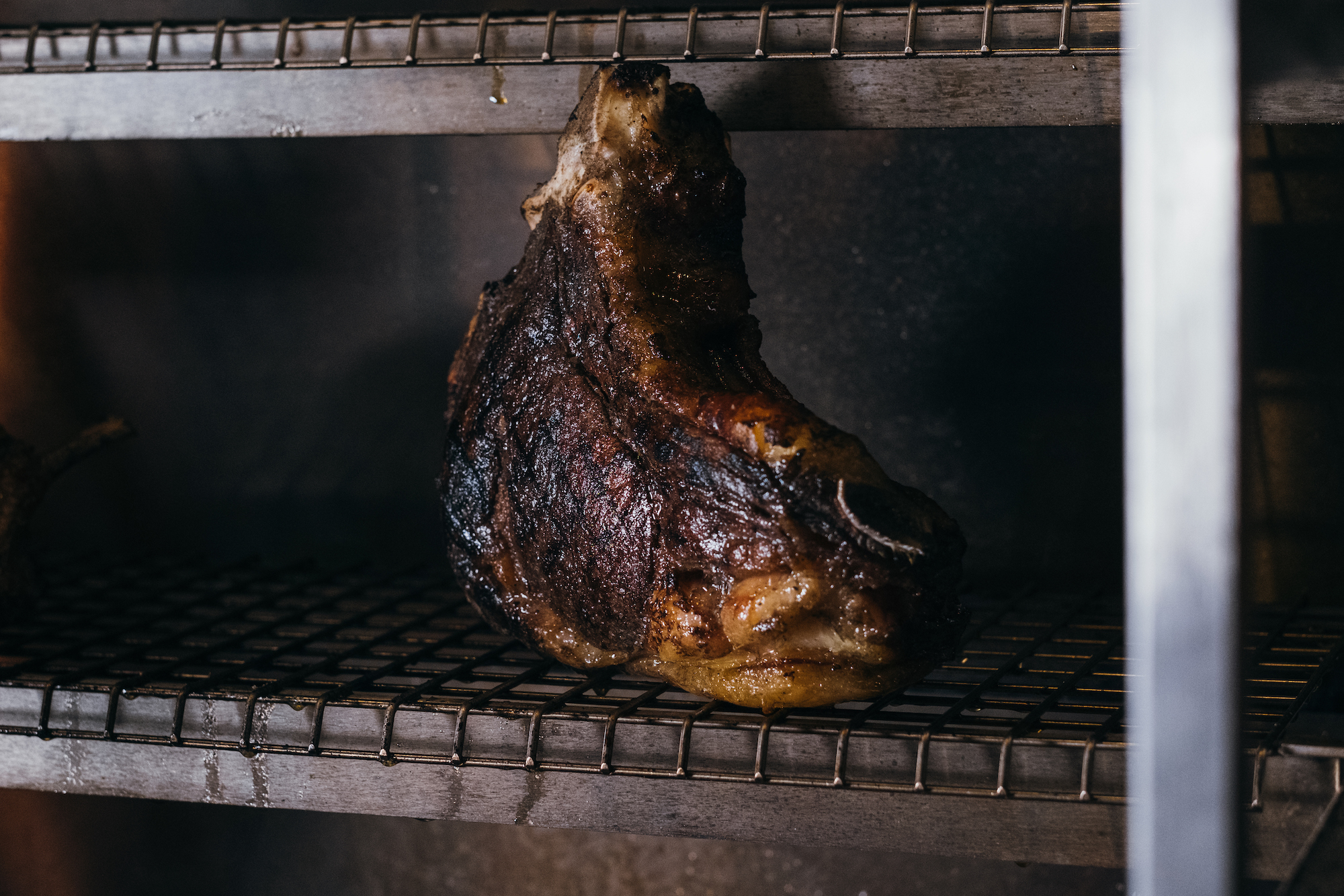 a large joint of beef which is situated nearby to the grill at the Coal Shed. The joint of beef is resting.