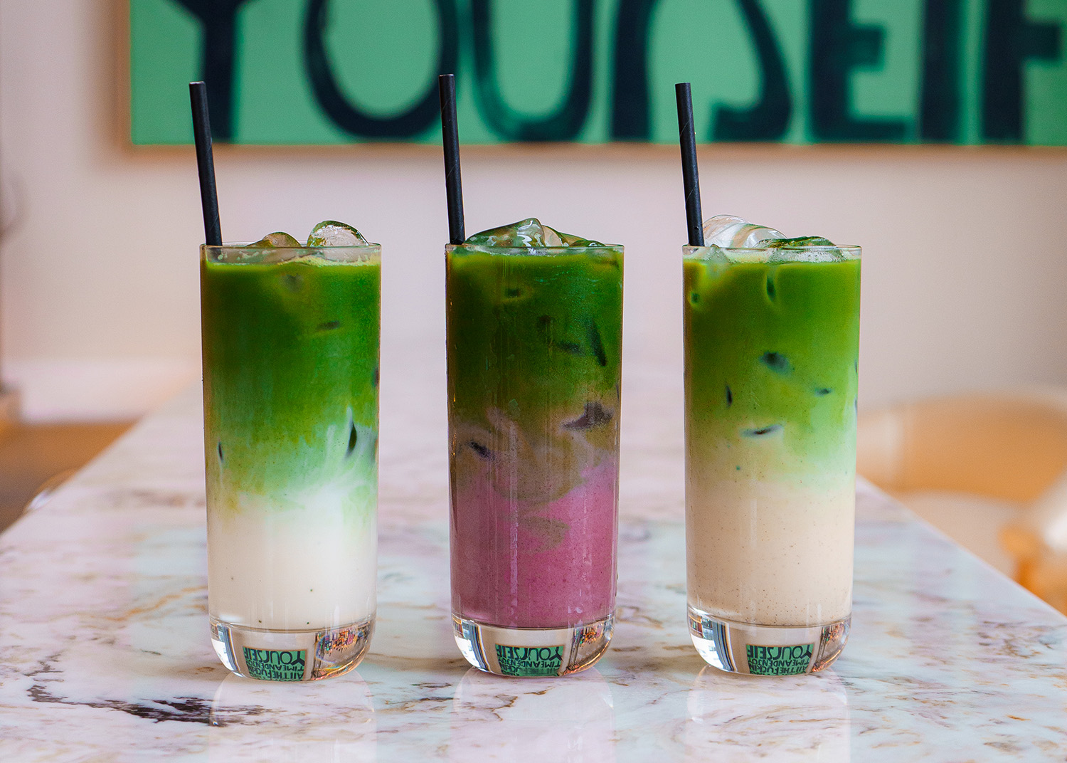 Three iced vanilla matcha lattes