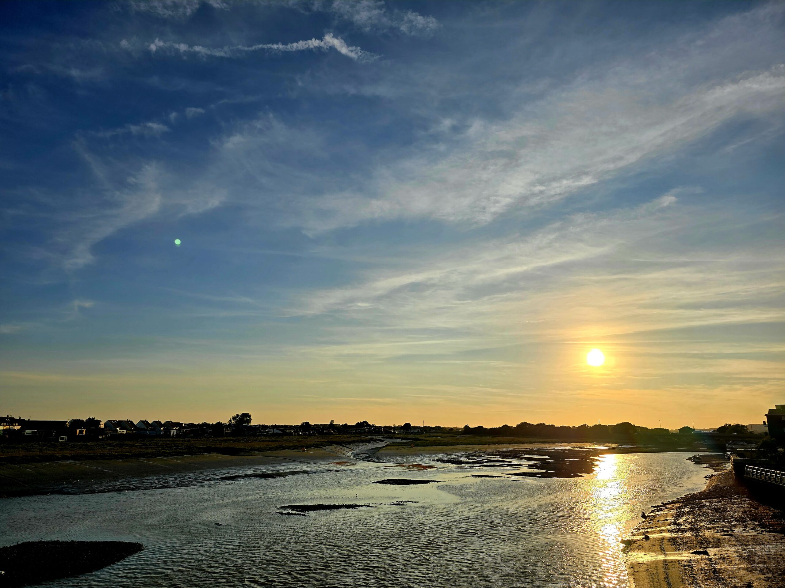 Sunset over the river adur. big blue sky and yellow sunshine