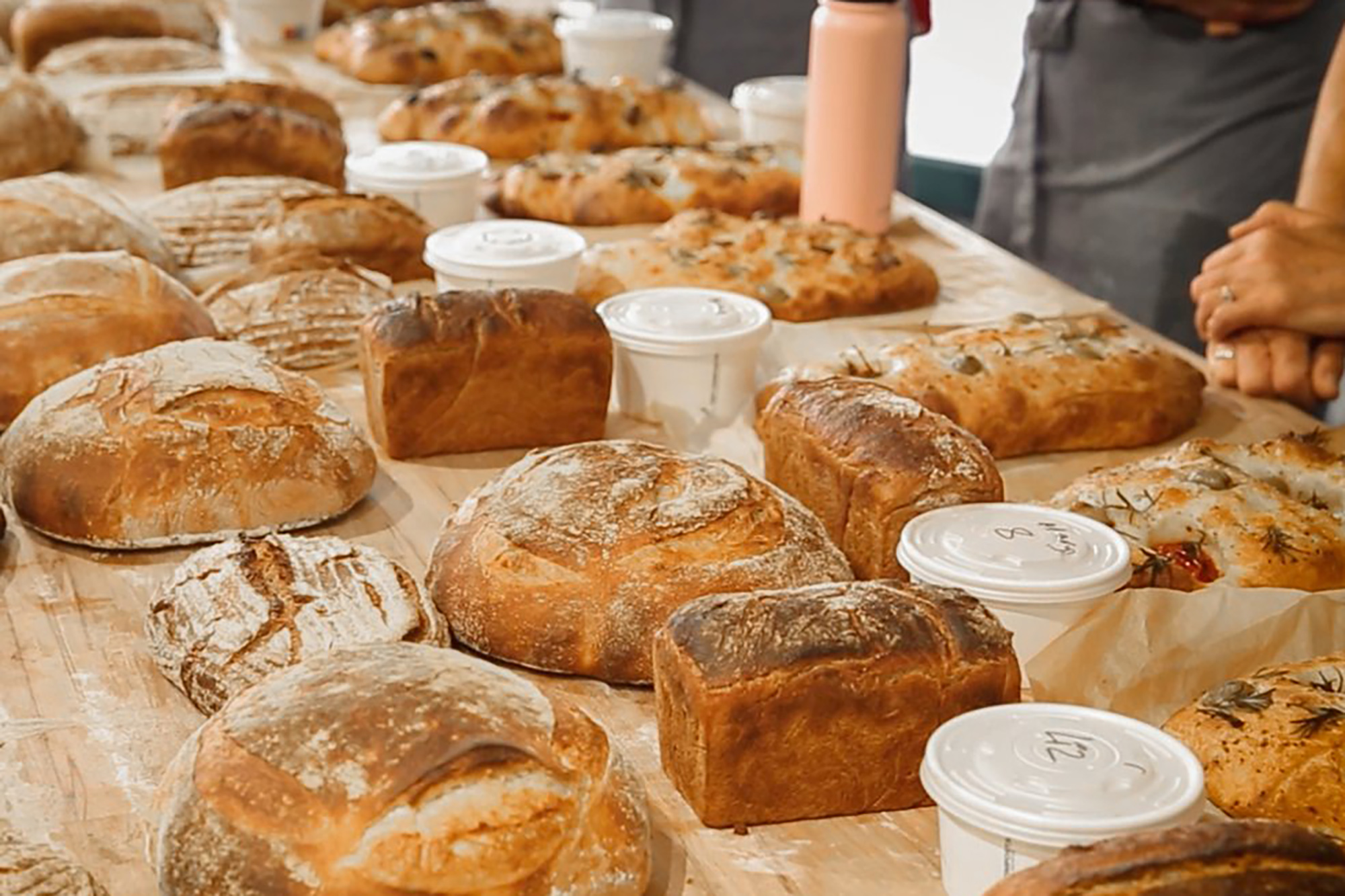 Table laden with loaves of bread in every shape and size