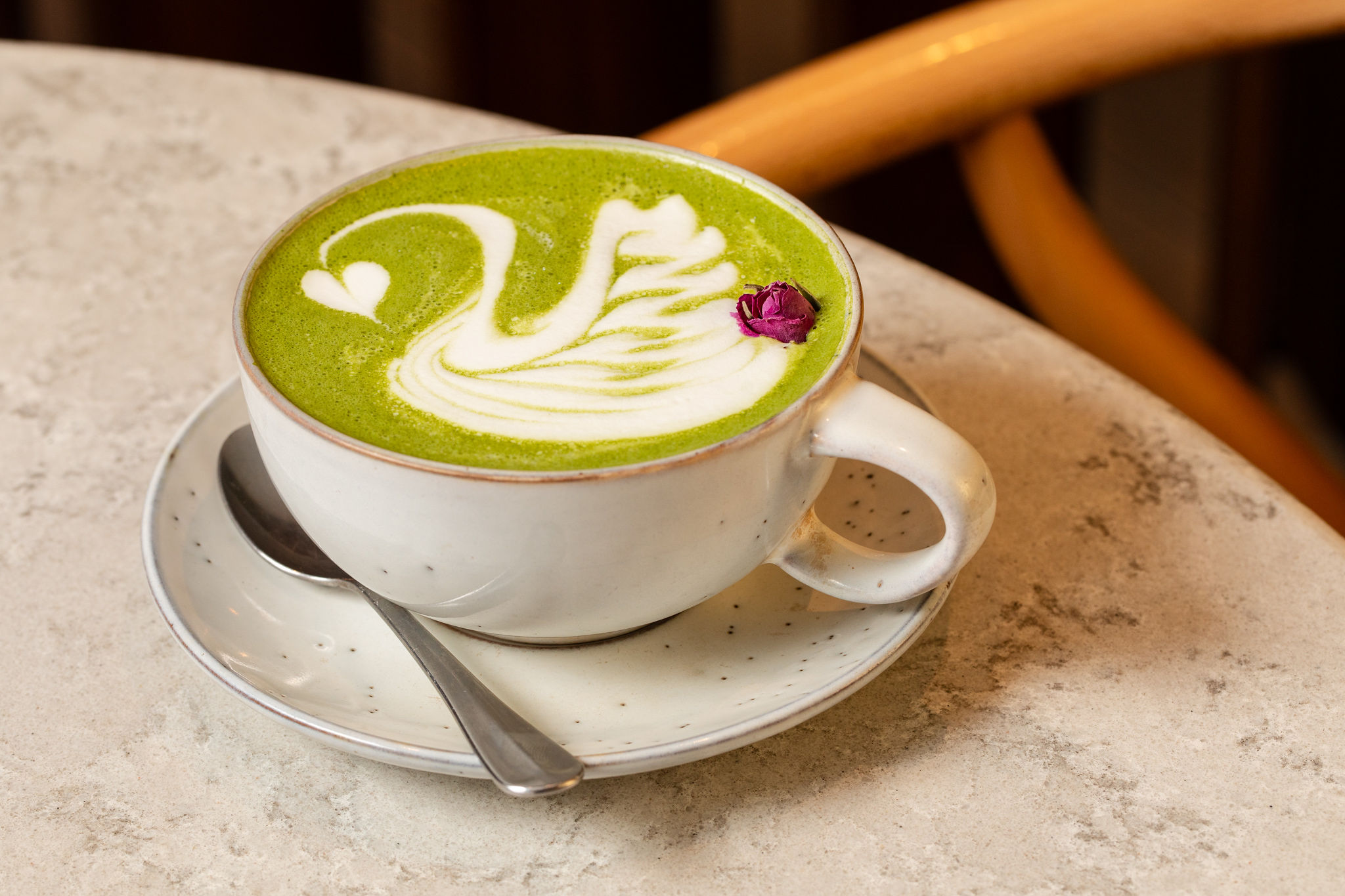 yellow curry being spooned out of a black bowl
