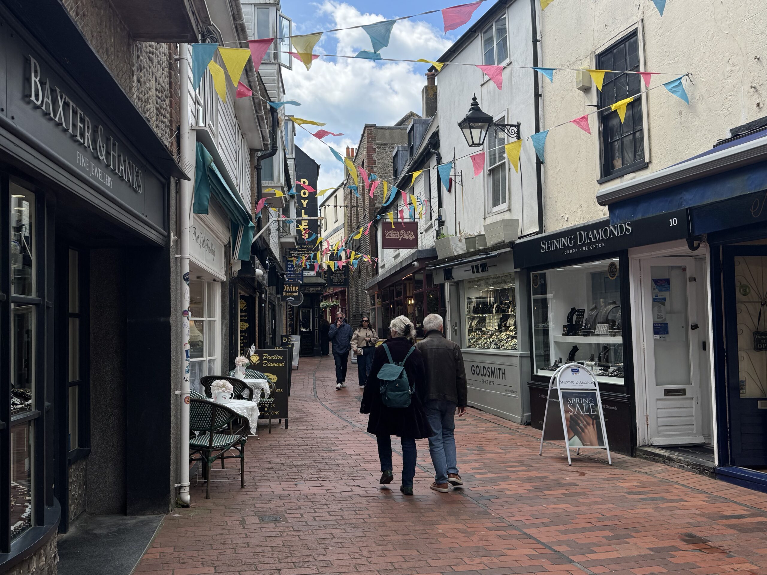 a couple wondering through Brighton's Lanes. A great place in the city to wonder around the twittens and see all the independent boutiques. 