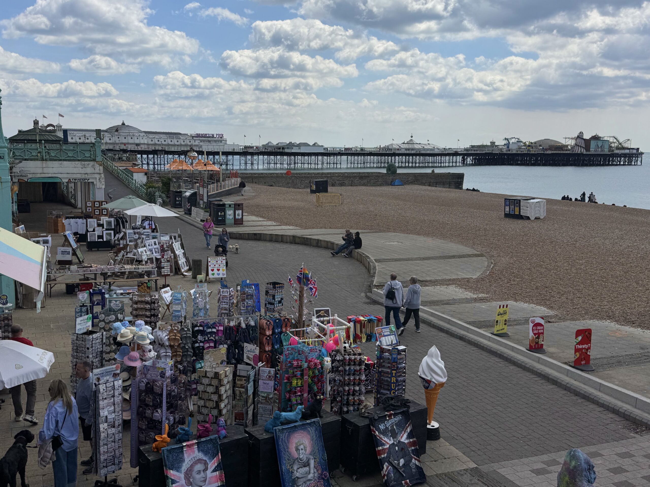Brighton Seafront, with the pier in the background. With bucket and spade shops. 