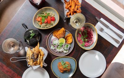 Table laid out for two with four dishes and sides